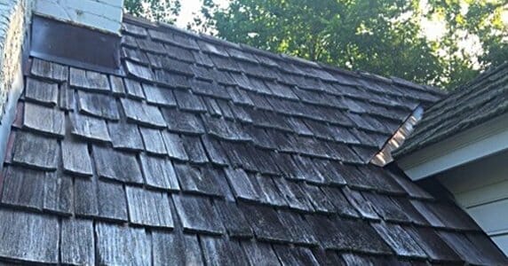 A house with a brown shingled roof.